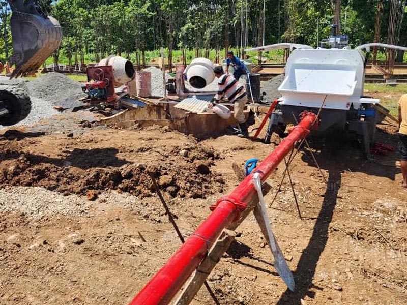 concrete pump is pumping at working site